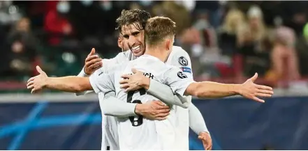  ?? — AP ?? Saviour: Bayern’s Joshua Kimmich celebrates with teammate Javi Martinez after scoring his side’s second goal during the Champions League Group A match against Lokomotiv Moscow.