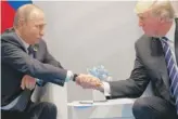  ?? EVAN VUCCI/AP FILE ?? President Donald Trump shakes hands with Russian President Vladimir Putin at the G20 Summit on July 7, 2017, in Hamburg.