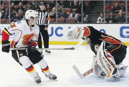  ?? ALEX GALLARDO/ THE ASSOCIATED PRESS ?? Calgary Flames forward Johnny Gaudreau knows more than most that it’s “tough to find the net” on Anaheim Ducks goalie John Gibson. The two were teammates for the U.S. at the 2013 world juniors when Gibson was named tournament MVP and top goalie.