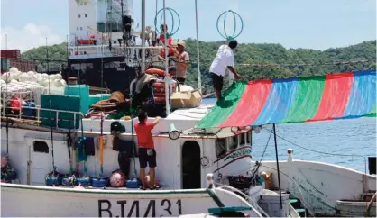  ??  ?? In this Sept 28, 2016 photo released by the Nature Conservanc­y, a longline tuna boat prepares for their next fishing trip in Palau. Cameras are recording everything that comes over the rail and onto the deck of a few dozen tuna boats loaded with motion...