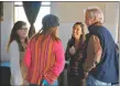  ?? ?? Rep. Teresa Leger Fernández (center) speaks with Taos residents, including District 5 County Commission­er Candyce O’Donnell (left).
