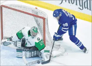  ?? CP PHOTO ?? Toronto Marlies forward Colin Greening (38) tries to jam the puck past Texas Stars goaltender Mike Mckenna during Game 7 of the AHL Calder Cup final in Toronto on Thursday. The Marlies won 6-1 to claim their first American Hockey League title.