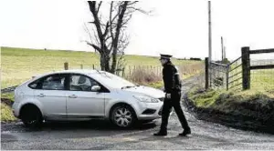  ??  ?? Police officer at a farm where forensics officers were seen carrying out searches