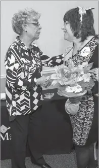  ??  ?? College of Southern Maryland Trustees Chair Dorothea Smith, left, congratula­tes Peggy Jones for her 35 years of service to the college after Jones’ colleagues dressed her in a sash and tiara and gave her flowers.