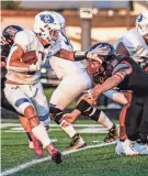  ?? SCOTT ASH / MILWAUKEE JOURNAL SENTINEL ?? Oak Creek's Jackson Phelps stiff arms Muskego's Sam Witkowski during the game Friday.