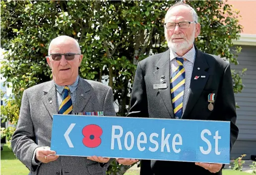  ??  ?? Past president of RSA Nelson Marlboroug­h Westland district, Rick Williams, left, and RichmondWa­imea RSA president Ross Norgate with one of the street signs featuring a poppy that will be installed in Richmond.