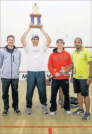  ??  ?? MAKING HEADWAY: East London squash open champ Gary Wheadon lifts the trophy, flanked by runner-up Jason le Roux (orange hoodie) and third-placed Kelvin Edwards, along with tournament organiser Tim Leeuw (green/yellow shirt)