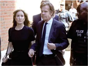  ?? AP PHOTO BY ELISE AMENDOLA ?? Felicity Huffman arrives at federal court with her husband William H. Macy for sentencing in a nationwide college admissions bribery scandal, Friday, Sept. 13, 2019, in Boston.