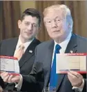  ?? Drew Angerer Getty I mages ?? HOUSE SPEAKER Paul Ryan and the president discuss their tax plan.