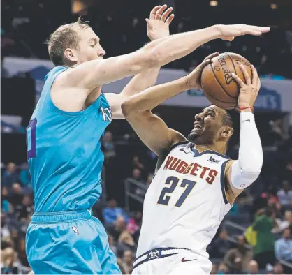  ?? Chuck Burton, The Associated Press ?? Denver’s Jamal Murray drives against Charlotte’s Cody Zeller during the second half on Friday.