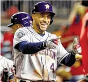  ?? Karen Warren / Staff photograph­er ?? George Springer reflects the Astros’ mood as they return in a far different state than when they left.