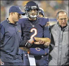  ?? STACY REVERE / GETTY IMAGES ?? Bears quarterbac­k Brian Hoyer, who had been subbing for the injured Jay Cutler, broke his left arm in Thursday night’s game against the Packers at Lambeau Field when he was hit by Julius Peppers. Subscriber­s can go to their ePaper for coverage.