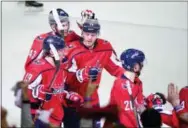  ?? NICK WASS — THE ASSOCIATED PRESS ?? The Capitals’ Nicklas Backstrom (19) celebrates his empty net goal with Tom Wilson (43), John Carlson (74), and Lars Eller (20), during the third period in Game 2 against the Penguins, Sunday in Washington. The Capitals won 4-1.