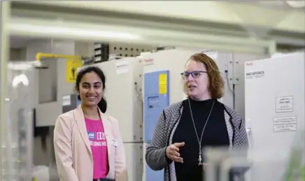  ?? IAN STEWART, SPECIAL TO THE RECORD ?? Muneeza Sheikh, left, a Milton high school student, tours a fish lab at Wilfrid Laurier University with university president Deborah MacLatchy.