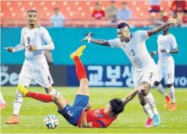  ?? ROBERT DUYOS/STAFF PHOTOGRAPH­ER ?? Korea’s Taehwi Kwak is sent tumbling to the ground in the first half on Monday.