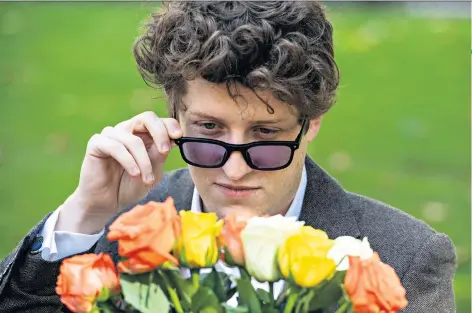  ?? ?? Testing, testing: Daniel Capurro tries out new glasses that help with colour blindness. Below, Claire Wills, with her sons Milo and Rafe, who are both colour blind