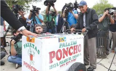  ?? ASSOCIATED PRESS PHOTOS ?? A grateful Fidencio Sanchez pushes his paletas cart one last time before a group of media after accepting a check for $384,290 during a news conference Sept. 21 outside the ice cream shop, Paleteria y Neveria Poncho, where he rented his paletas cart in...