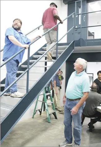  ?? Brodie Johnson • Times-Herald ?? Forrest City City Councilima­n Lowry Astin, right, talks with Rob Johnson as he climbs the stairs to see the bunks on the second floor where inmates will be housed in one of several pods at the new St. Francis County Detention Center. The faclity was opened to the public for tours this morning. Other tours will be given on Thursday and Friday, from 11 a.m. to 2 p.m.