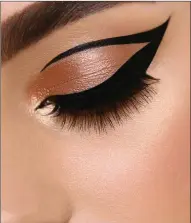  ??  ?? Eye make-up look with a thick cat-eye.