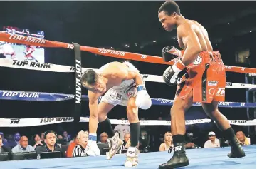  ?? — AFP photo ?? Hidenori Otake (left) of Japan stumbles in his fight with Isaac Dogboe of Ghana during the WBO junior featherwei­ght championsh­ip bout at Gila River Arena in Glendale, Arizona.