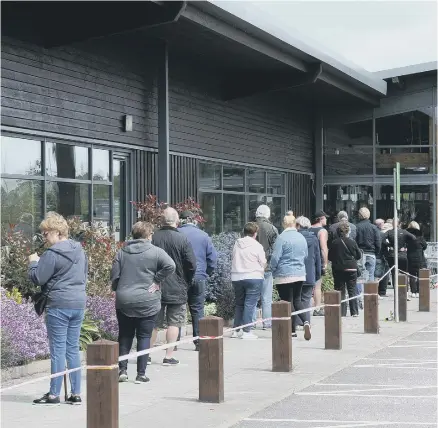  ??  ?? The queue to get into the newly re-opened Dobbies garden centre