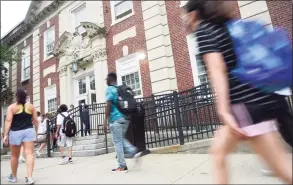  ?? Tyler Sizemore / Hearst Connecticu­t Media ?? Students enter the first day of school at Stamford High School on Monday. Stamford Public Schools students returned to class Monday to kick off in-person learning for the 2021-22 school year. Pandemic protocols were still in place as students and staff were masked, handwashin­g stations were available, and some sites even offered on-site COVID-19 testing.