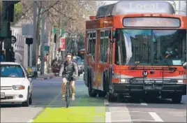  ?? Brian van der Brug Los Angeles Times ?? A BICYCLIST pedals in the green lane on Spring Street. The lane has been criticized by the film industry, which uses the street as a stand-in for other locales.