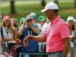  ?? JAMIE SQUIRE / GETTY IMAGES ?? Tiger Woods tries to decide on a club during Monday’s Masters practice round at Augusta National.