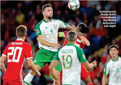  ??  ?? Embarassed: Shane Duffy rises above the Wales defenders last night