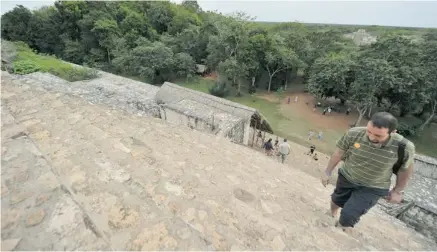  ?? PHOTOS: CRIS BOURONCLE/AFP/GETTY IMAGES ?? A tourist climbs the steep steps of the Acropolis at the archeologi­cal site of Ek Balam, built by the Mayan civilizati­on in the Yucatán Peninsula.