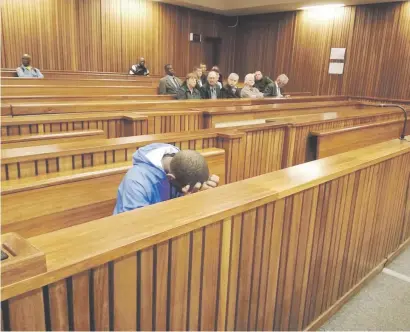  ?? Picture: Ilse de Lange ?? ACT OF ANGER. Self-confessed double murderer January Mahlangu hides his face while his victims’ family look on.