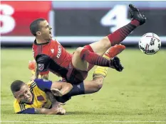  ?? NATHAN DENETTE/THE CANADIAN PRESS ?? Colorado defender Kortne Ford and Toronto FC’s Sebastian Giovinco battle for the ball last month in Toronto. It’s first against worst in the MLS on Saturday as league-leading Toronto FC travels to D.C. United on the heels of dropping two points in a 1-1 tie with lowly Colorado Rapids.