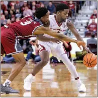  ?? Arkansas Democrat-Gazette/MITCHELL PE MASILUN ?? Arkansas guard Daryl Macon (right) steals the ball from Troy guard Wesley Person Jr. on Saturday at Verizon Arena in North Little Rock. Macon has 39 assists and 17 turnovers, which is tied for fifth in the SEC in assist-to-turnover ratio.