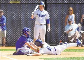  ?? Matthew Brown / Hearst Connecticu­t Media ?? Danbury catcher Jake Matson tags out Darien's Devyn Kippnut in the second inning of the Blue Wave’s 8-2 victory on Saturday in the FCIAC quarterfin­als in Darien.