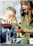  ?? KEVIN WINTER/GETTY IMAGES ?? Actor Channing Tatum, left, pours actor Halle Berry a drink onstage at the 20th Century FOX panel during Comic-Con Internatio­nal 2017 at San Diego Convention Center on Thursday in San Diego, California.