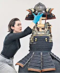  ?? Japan: Courts and Culture exhibition in April ?? A samurai suit of armour is prepared for the