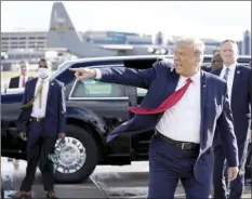  ??  ?? President Donald Trump gestures to supporters as he arrives at Minneapoli­s Saint Paul Internatio­nal Airport on Wednesday.