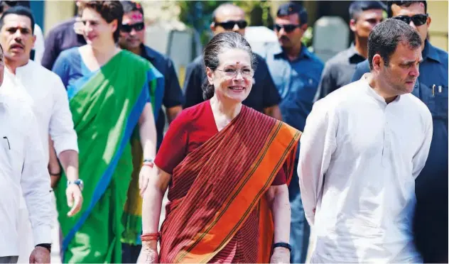  ?? Agence France-presse ?? ↑ Sonia Gandhi, Rahul Gandhi and Priyanka Gandhi arrive to file her nomination papers for general election at Rae Bareilly district court.