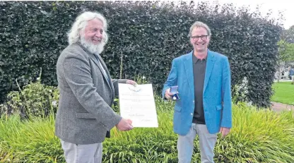  ??  ?? Caley president David Knott, left, presented Keith Jackson with the medal.