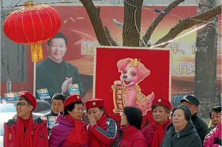  ?? PHOTO: AP ?? A billboard showing Xi Jinping looks down on residents celebratin­g a lantern festival to mark the end of winter in a residentia­l compound for retired soldiers in Beijing.