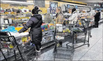  ?? Nam Y. Huh The Associated Press ?? Customers wait for orders at a grocery store in Wheeling, Ill., on Jan. 19. On Friday, the Commerce Department issues its December report on consumer spending.