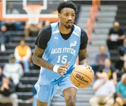  ?? KENDALL WARNER/STAFF ?? Sales Systems Ltd. forward Kalib Boone of UNLV looks to drive in a 96-78 defeat to Portsmouth Partnershi­p on Thursday night in the Portsmouth Invitation­al Tournament at Churchland High. Boone had nine rebounds but no points in his first two PIT games.