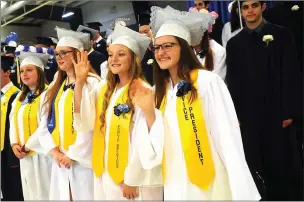  ?? Photo by Ernest A. Brown ?? In front row, from left, Burrillvil­le graduates Paige Desjardin, Joann Roberts, Ally Simpson, and Courtney Gouin wave to family members during Burrillvil­le High School's 116th commenceme­nt at Levy Arena Friday.
