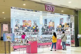  ?? AP ?? People shop at a Vern’s outlet at a shopping mall in Kuala Lumpur, Malaysia, Monday, April 8, 2024. Vern’s Holdings, a Malaysian shoe company has apologized and stopped selling some of its footwear after some Muslims said the logo resembled the Arabic writing for the word God.