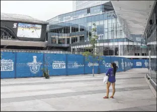  ?? Jason Franson The Associated Press ?? While the NHL playoffs go on inside the bubble at Rogers Place in Edmoton, Alberta, fans are relegated to watching on the big screen outside.