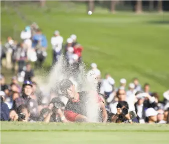  ?? Photos by Chung Sung-Jun / Getty Images ?? Tiger Woods hits out of a bunker on No. 18 during the final round of the Zozo Championsh­ip. Woods’ sand shot stopped 10 feet from the flag, and he followed by sinking a birdie putt.