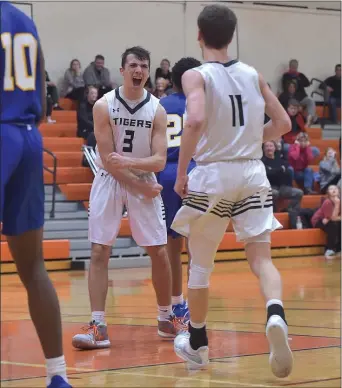  ?? PETE BANNAN - MEDIANEWS GROUP ?? Marple Newtown’s Joey Paoletti, left, celebrates with teammate Michael Tansey after sinking a basket and drawing a foul to put the Tiger ahead for the first time in the fourth quarter against Springfiel­d. The Tigers won, 47-43.