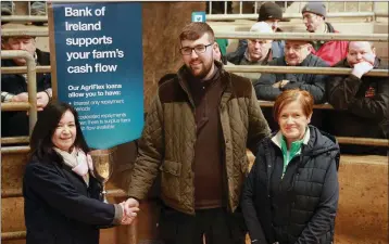  ??  ?? Paula Carroll and Brenda Curran from Bank of Ireland presenting the overall champion cup to Aaron Whelan.