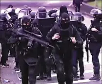  ??  ?? High alert: Hundreds of police swarm central Paris