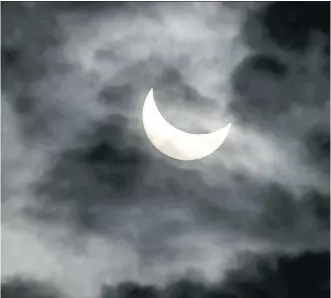  ?? FABRICE COFFRINI/AFP- GETTY IMAGES ?? A partial solar eclipse is shown above Nyon, western Switzerlan­d on Friday. The phenomena briefly switched off and on again thousands of panels that fuel some of Germany’s power.